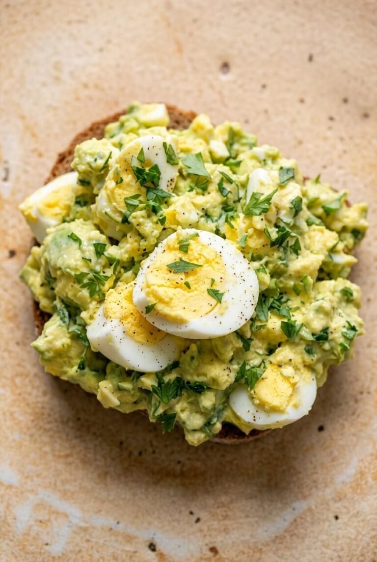 avocado egg salad recipe - Avocado Egg Salad served in a white bowl overhead view