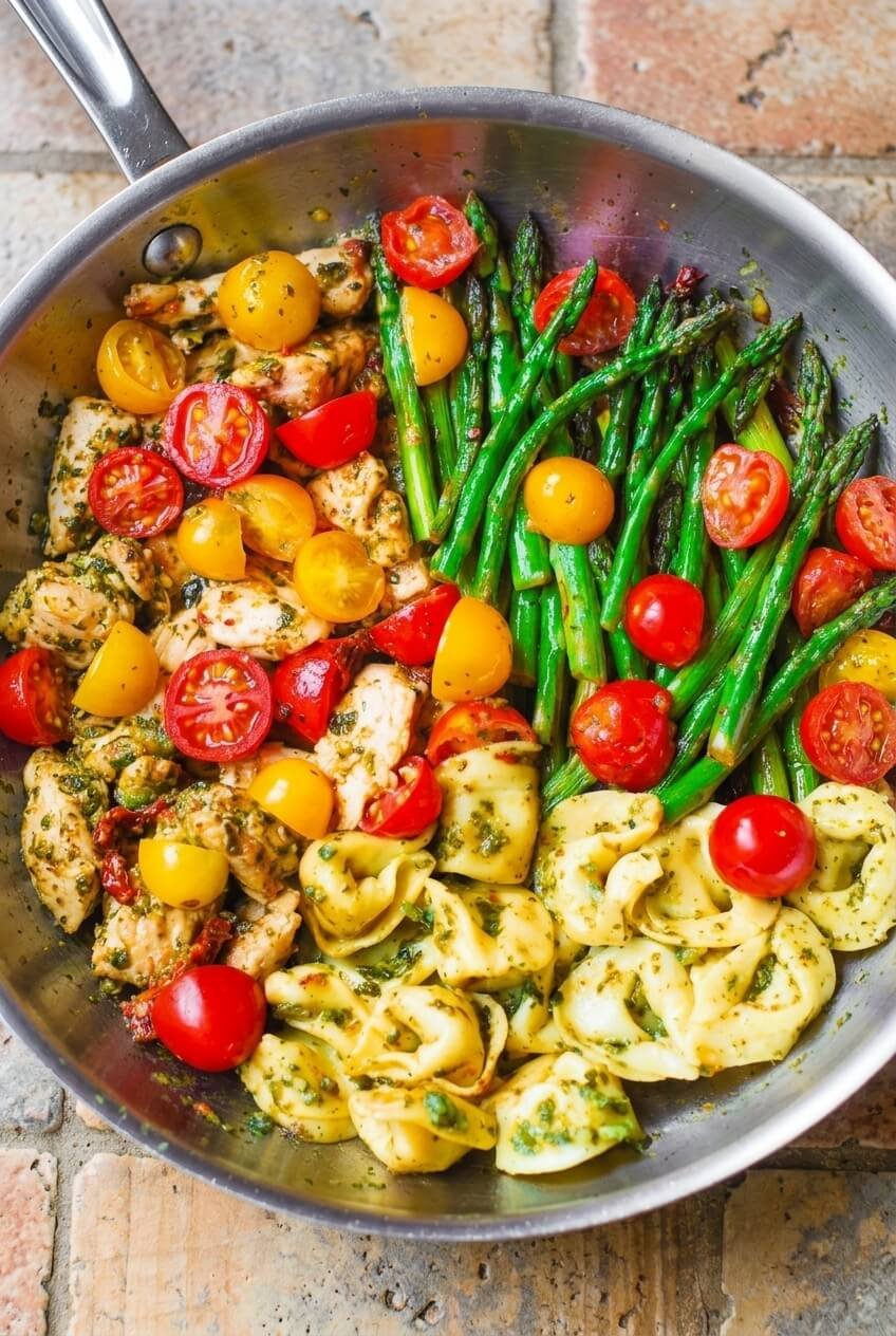 pesto chicken and tortellini skillet recipe - Pesto Chicken and Tortellini Skillet served in a white bowl overhead view