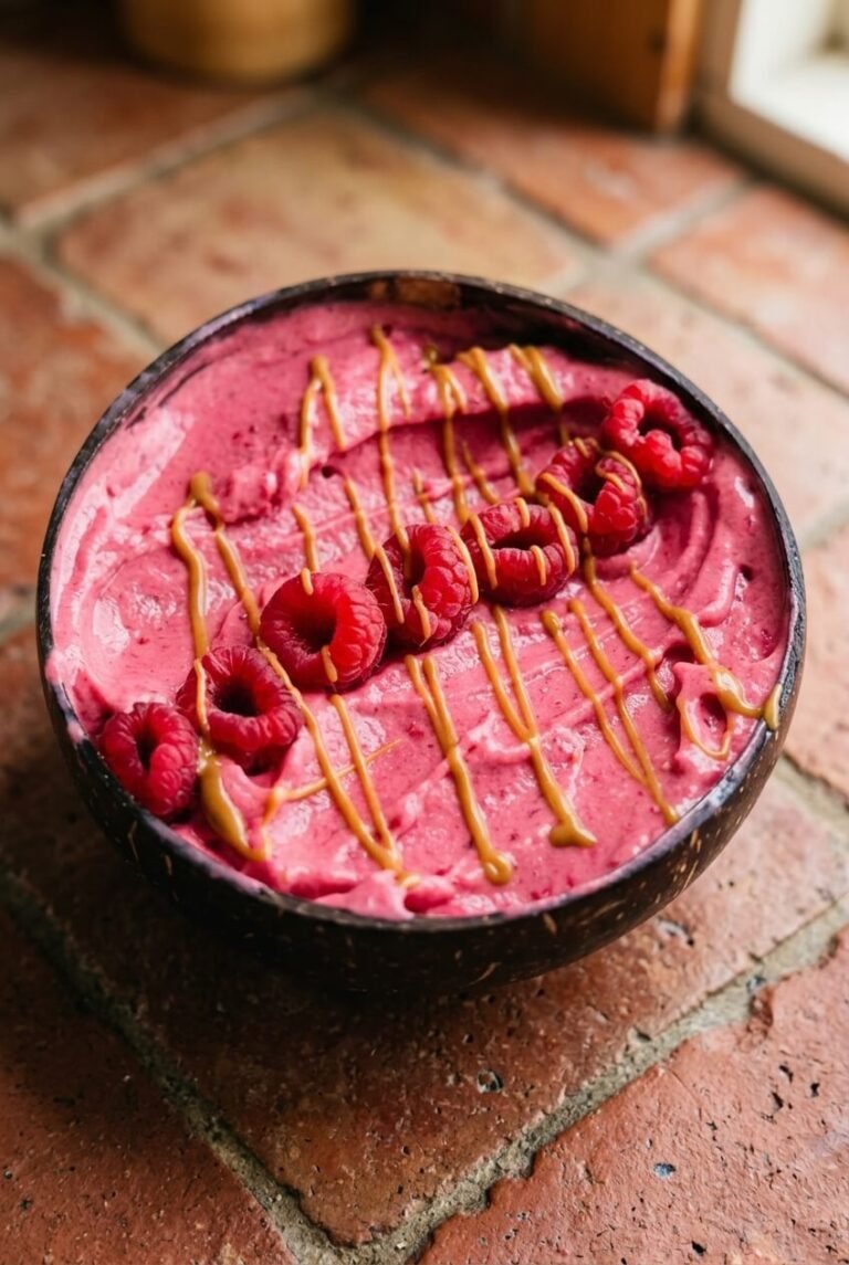 raspberry smoothie bowl recipe - Raspberry Smoothie Bowl served in a white bowl overhead view
